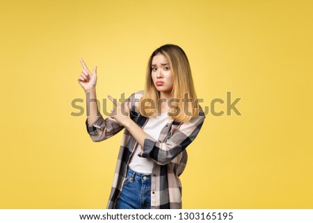 young attractive asian woman who points to the finger with unhappy emotion.