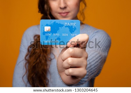 Picture of a girl holding blue credit card