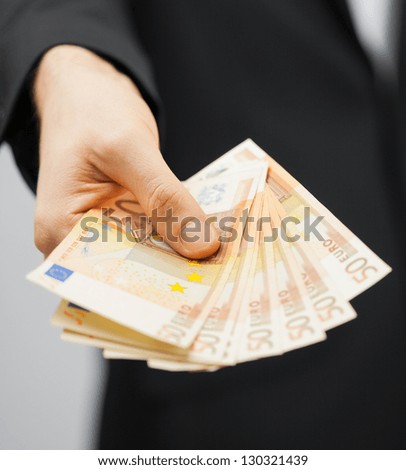 picture of man in suit with euro cash money.