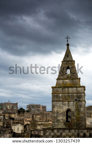 Vertical View of the City of Matera on Cloudy Sky Background
