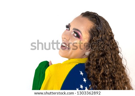 Brazilian woman fan holding the flag of Brazil on white background.Young smiling Brazilian woman smiling to camera with the flag