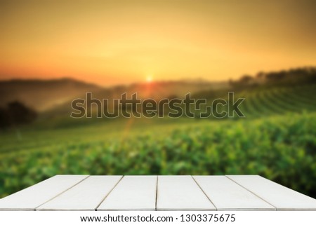 Empty wooden table with view of mountain or wooden desk with plantation nature with bokeh background, copy space for your text