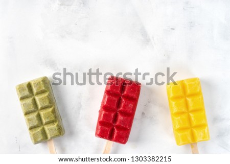 Fruit colorful sorbet popsicles on white background