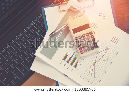 Business report chart preparing graphs calculator on laptop / Summary report in Statistics circle Pie chart on paper business document financial chart and graph with  pen on top view 