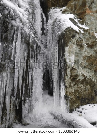 small cave covered in icicles