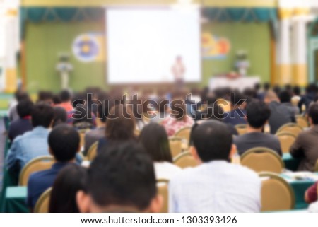 Abstract blurred photo background of business people in conference hall or seminar room. Bokeh business meeting conference training learning coaching concept. 
