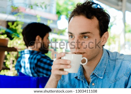 Young man taking a coffee break at coffee shop.