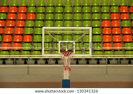 Basketball hoop and seats in stadium .