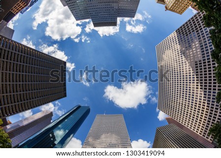 Skyward fisheye view of modern downtown skyscrapers.