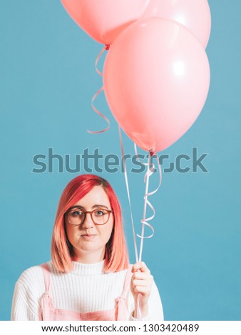 Woman holding a pastel pink balloon