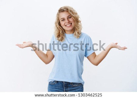 Who cares chill and be happy. Portrait of charismatic carefree young 25s girl with blue eyes tilting head joyfully as shrugging unaware and unbothered, spread hands sideways in clueless gesture
