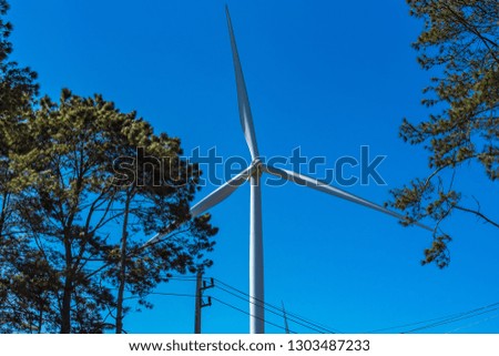 Power of wind turbine generating electricity clean energy with cloud background on the blue sky.Global ecology.Clean energy concept save the world