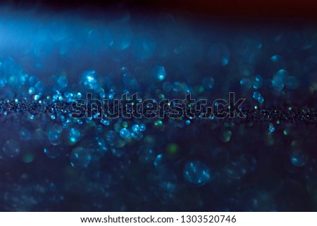 blue glitter magic background with dark gradient. Defocused light and free focused place for your design. Abstract background