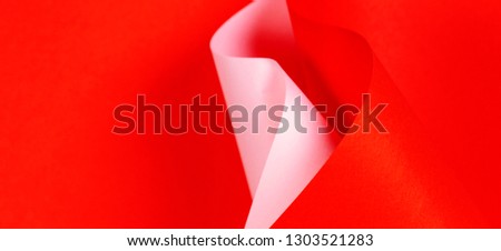 Abstract colorful background with red and pink paper in geometric shapes. Selective focus