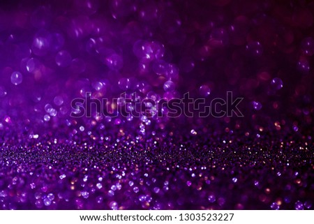 Purple glitter magic background. Defocused light and free focused place for your design. Abstract background