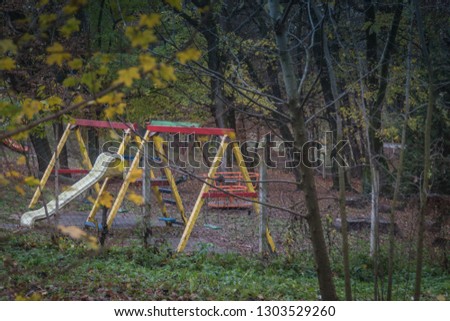 Rainy muddy children playground at autumn abandoned