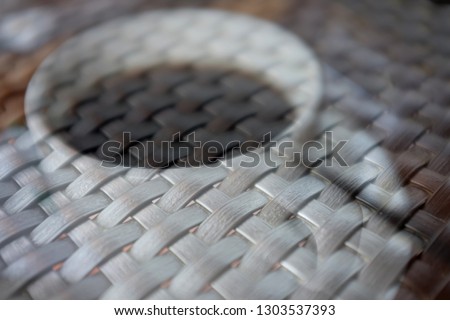 Double exposure of coffee cup with weave table matt