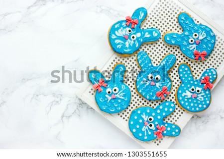 Easter bunny cookies, homemade painted gingerbread biscuits in glaze shaped funny rabbits for Easter treats