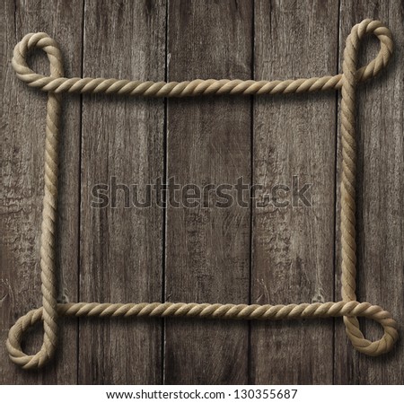 aged rope frame on old wood background