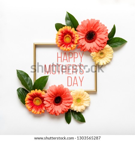 Happy Mother's Day Living Coral Pantone Color Background. Flat lay greeting card with beautiful coral hue gerbera flowers on white background.