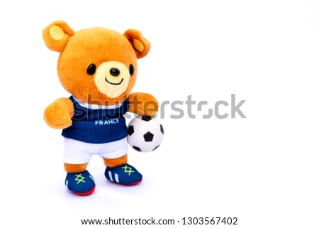 Teddy bear athlete France player with ball isolated on white background.