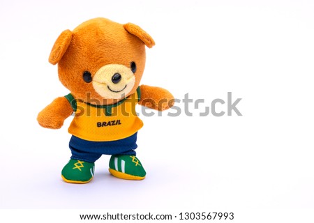 Teddy bear athlete in Brazil dressed player isolated on white background.