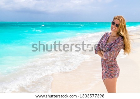 Gorgeous woman with blowing hair on the dream beach