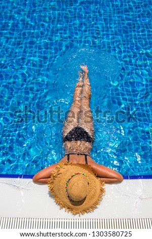 Young woman in swimming pool Royalty-Free Stock Photo #1303580725