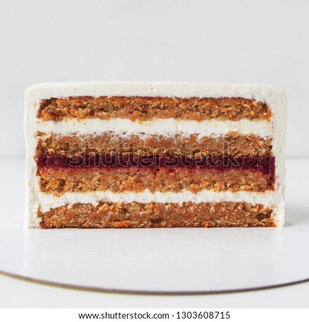 Cream and berrys cake slice with cream filling in section on a plate, white background. Cake slit. Food blog concept. Receipt. Piece of tasty cake. High cooking. Space for text. Copy space. French. 