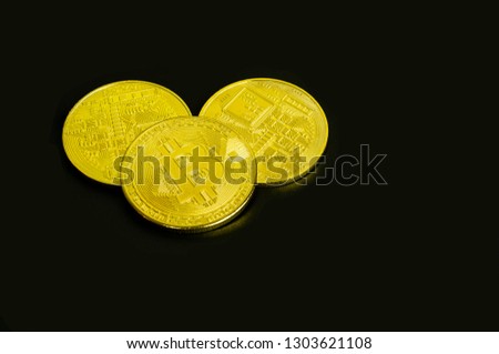 closeup of gold bitcoins on black background.bitcoin logo in the dark (new virtual money )- Image
