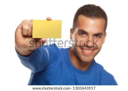 portrait of happy young man, holding empty credit card on white background
