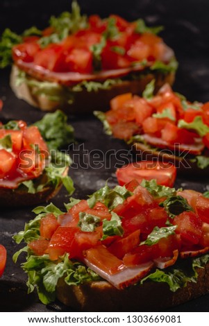 Italian tomato bruschetta with chopped vegetables, herbs and oil on grilled or toasted crusty ciabatta bread