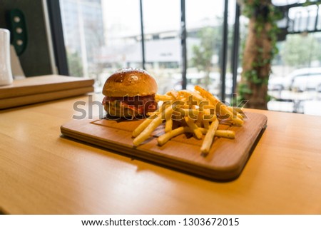 A hamburger, beefburger or burger is a sandwich consisting of one or more cooked patties of ground meat, usually beef, placed inside a sliced bread roll or bun.
