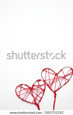 Valentine's Day. Valentine's Day Background with Two Red Thread Hearts. Romantic Holiday Background with Hearts. Holiday of Love.