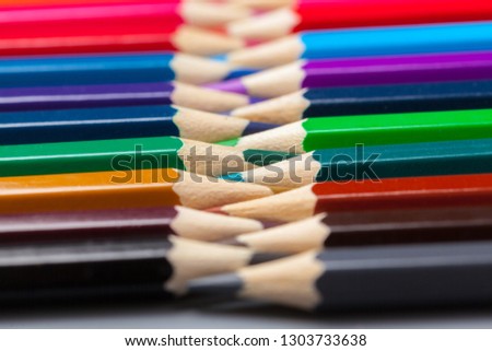 Set of colored pastel pencils in row multi color in form of closed zipper