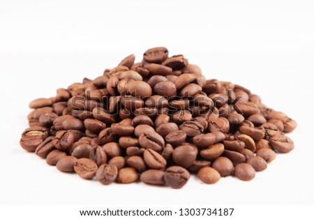 
Textured brown coffee beans on a white background.