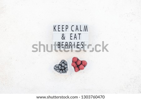Creative Valentine Day romantic concept composition flat lay top view keep calm eat berries quote raspberry blueberry table background copy space Template greeting card text social media blogs