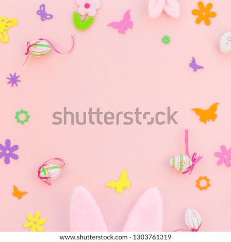 Creative Top view flat lay holiday composition Easter eggs bunny ears spring flowers on pink paper background copy space Template Easter day seasonal pattern