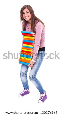 Picture of a student girl carrying a pile of books, she can hardly hold them. Studio shot.