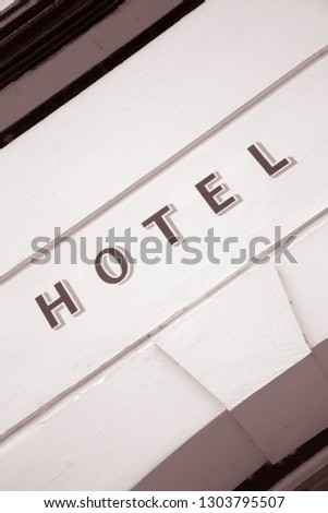 Hotel Sign on Building Facade in Black and White Sepia Tone