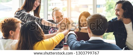 Gesture hand high five of Group employee laughing together with achivement mission at millenial company. Casual business with startup friends teamwork community celebration, win and conquest concept Royalty-Free Stock Photo #1303799767
