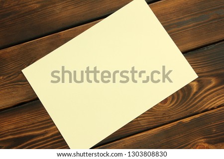 Paper on wooden background. With space for your text.