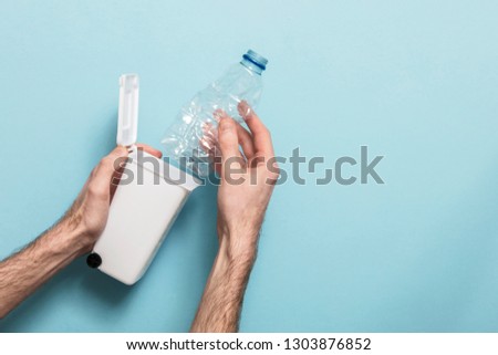 Recycle plastic bottles. Hands putting bottle into a bin
