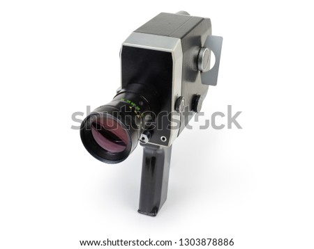Old amateur film movie camera Super 8mm format powered by clockwork motor on a white background 

