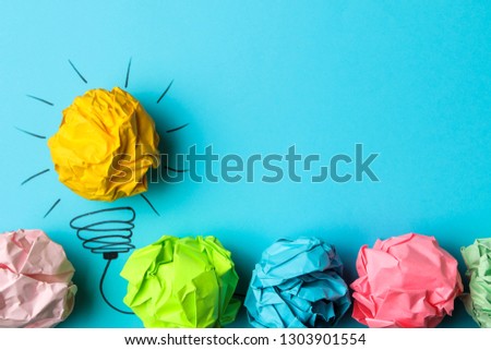Concept creative idea. concept of creative idea. Crumpled paper balls and painted light bulb on bright background. metaphor, inspiration.