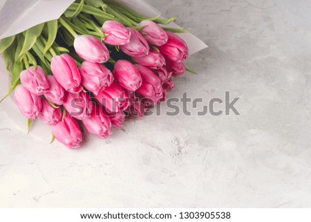 bouquet of pink tulips on a light concrete background