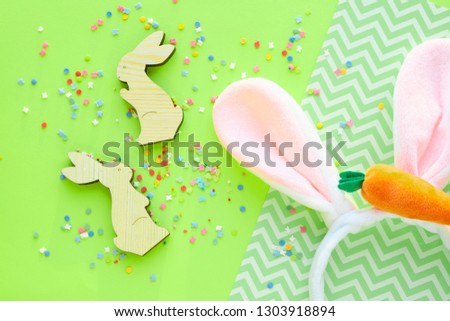 colorful background for easter, wooden bunnies and sweets