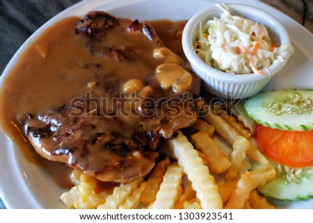 A picture of special hainanese mushroom sauce chicken chop for lunch.