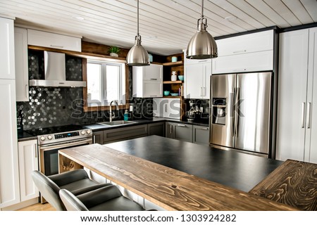 Modern gray kitchen in a beautiful house Royalty-Free Stock Photo #1303924282