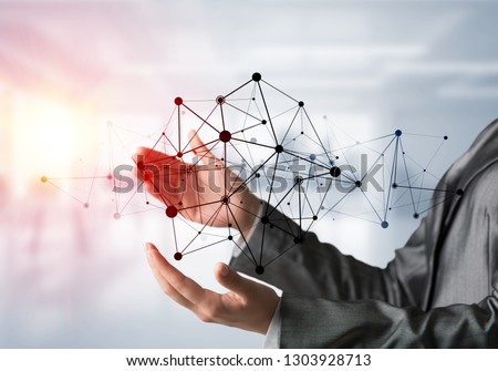 Business woman in suit keeping black social media network structure in hands with sunlight and office view on background. Mixed media.